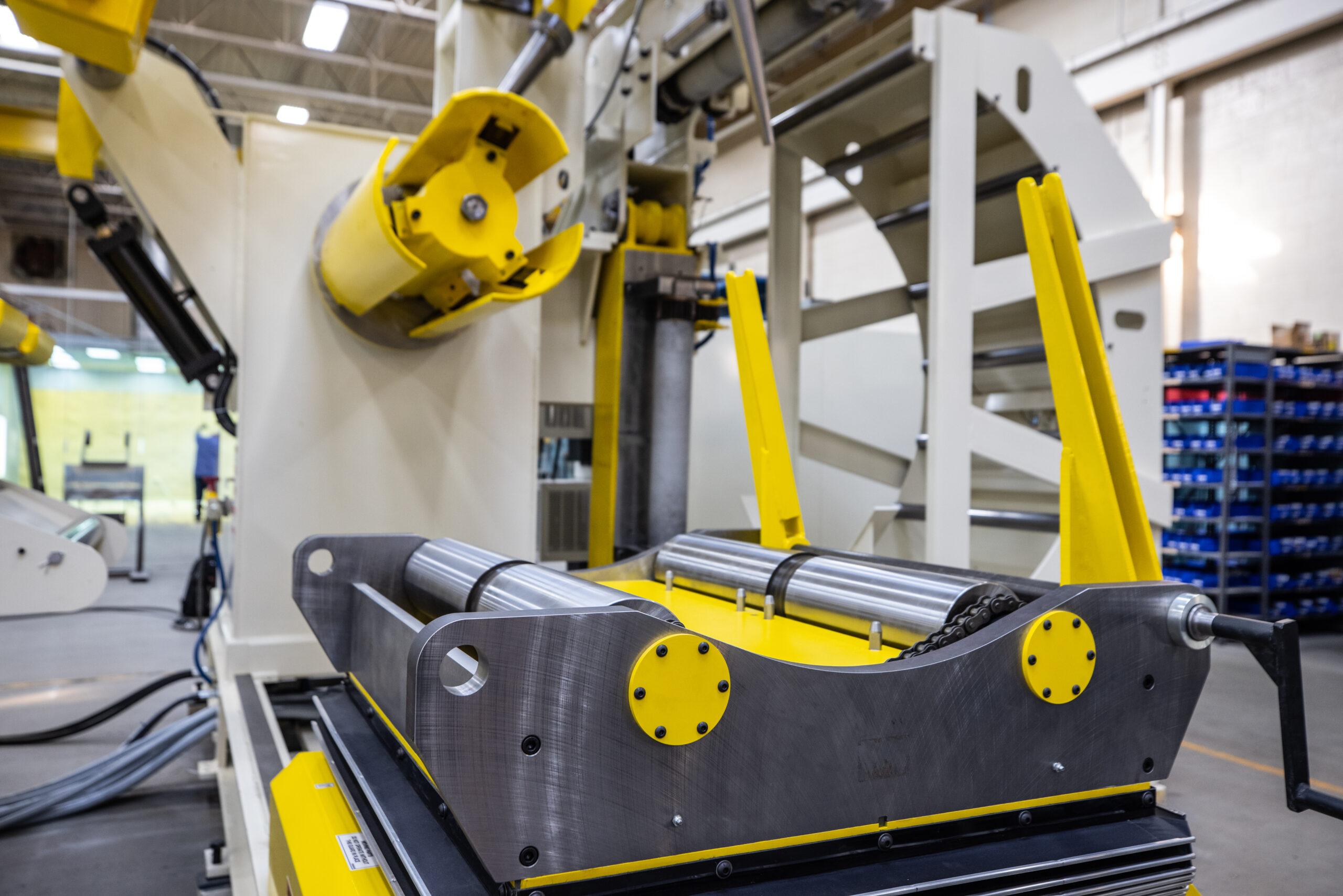 What is a coil car? Industrial coil car staging a steel coil in front of a compact decoiler for loading.