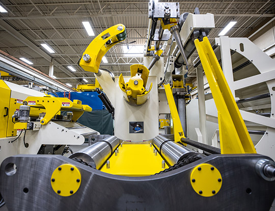 High strength steel stamping compact line in COE Press Equipment’s Sterling Heights, Michigan assembly shop, showing the coil car in the foreground for accurate, efficient coil loading onto the mandrel.